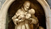 A marble sculpture of St. Cajetan holding the infant Jesus identifies the spot where the saint’s vision occurred in the crypt of the Chapel of the Nativity, the side chapel to the right of the main altar of the Basilica of St. Mary Major in Rome.