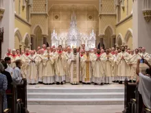 Bishop Jacques Fabre-Jeune poses alongside many of the priests of the Diocese of Charleston at a recent ordination. The diocese has seen a recent surge in vocations.