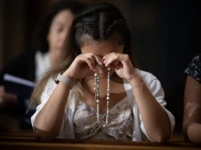 A woman prays the rosary at the Dominican Rosary Pilgrimage at the National Shrine of the Immaculate Conception in Washington, DC, on Sept. 28, 2024.