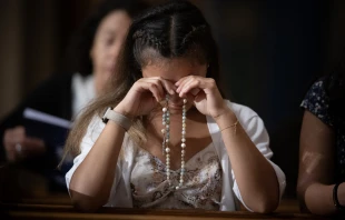 A woman prays the rosary at the Dominican Rosary Pilgrimage at the National Shrine of the Immaculate Conception in Washington, DC, on Sept. 28, 2024. Credit: Jeffrey Bruno