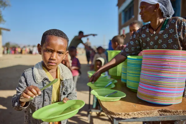 A boy about to be served a meal at Tsehafe Werdi Primary School, in Tigray, Ethiopia. The Daughters of Charity, supported by Mary's Meals, has provided meals to thousands of children through a school feeding program since 2017. March 2024. Armstrong Studios // 2024