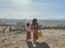 A woman and a girl in Tigray walk with supplies. The founder and CEO of the global school-feeding charity Mary’s Meals visited northern Ethiopia in March and confirmed reports of a widespread hunger crisis unfolding rapidly in Tigray in the aftermath of a two-year civil war and ongoing drought. 