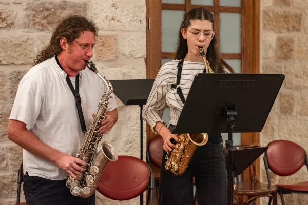 Daniel Sinchuk, a saxophone teacher of Russian Jewish origin from the Magnificat Institute with his Arab student during a duet during a performance on May 30, 2024. In the classrooms of the Magnificat Institute of Jerusalem, the music school of the Custody of the Holy Land located in the heart of the Old City, Israeli and Palestinian students and teachers of Jewish, Muslim, and Christian faiths continue to meet and make music together while the longest war since the founding of the State of Israel, now in its ninth month, continues. Credit: Marinella Bandini