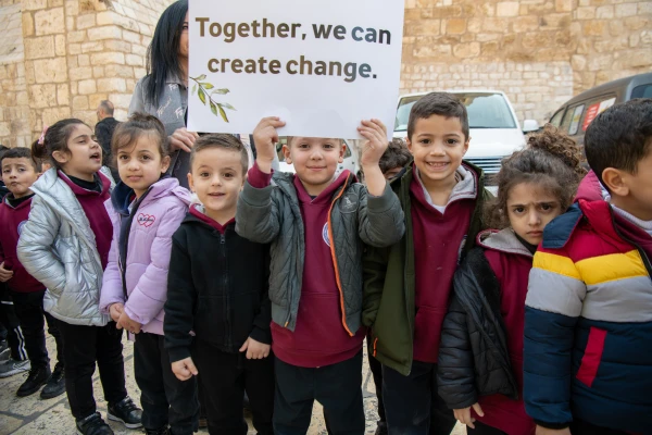 Many children welcomed the custos of the Holy Land, Father Francesco Patton, upon his entrance into Bethlehem on Nov. 30, 2024, for the beginning of Advent. The custos’ entry was festive, but at the same time, it was impossible to ignore the echoes of war. The children were holding signs with messages of peace and solidarity for those suffering due to the war. Credit: Marinella Bandini