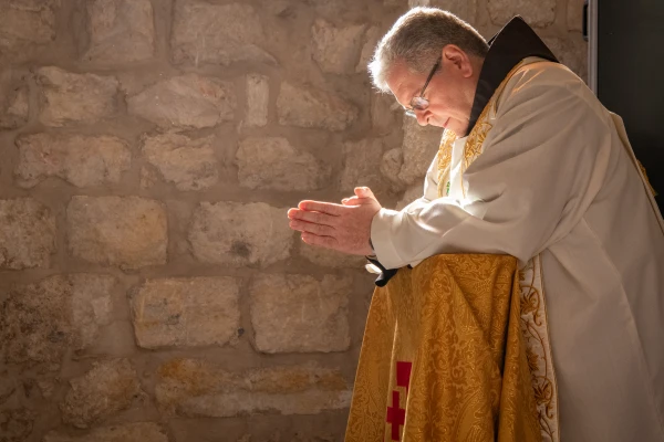 The custos of the Holy Land, Father Francesco Patton, prays in front of the altar of St. Catherine in the church of the same name in Bethlehem (the Latin part of the Basilica of the Nativity complex) immediately after his solemn entrance into the city and the basilica on Nov. 30, 2024, for the beginning of Advent. Credit: Marinella Bandini