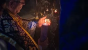 The custos of the Holy Land, Father Francesco Patton, lights the first candle of the Advent wreath at the site of the manger inside the Nativity Grotto on Nov. 30, 2024, during the first vespers of the first Sunday of Advent.