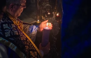 The custos of the Holy Land, Father Francesco Patton, lights the first candle of the Advent wreath at the site of the manger inside the Nativity Grotto on Nov. 30, 2024, during the first vespers of the first Sunday of Advent. Credit: Marinella Bandini