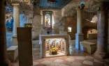 The interior of the Milk Grotto in Bethlehem. In the background, the most well-known depiction of Our Lady of the Milk. According to a Christian tradition dating back to the sixth century, the Virgin Mary was nursing the baby Jesus here, and when, in haste to flee to Egypt, she took him off her breast, a drop of milk fell to the ground, turning the stone completely white.