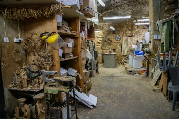 The "Olive Wood Factory" workshop of Bassem Giacaman in Bethlehem has been closed for over a year. The workshop machinery sits idle most of the time, the workforce has been halved, and the remaining workers usually only work two or three days a week — there simply isn’t enough work for everyone. Credit: Marinella Bandini