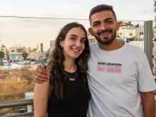 Sabeen Rahil and Elias Johny Al Arja in Bethlehem. In the background behind them is the bell tower of the Church of the Nativity, which stands on the site where Jesus was born.