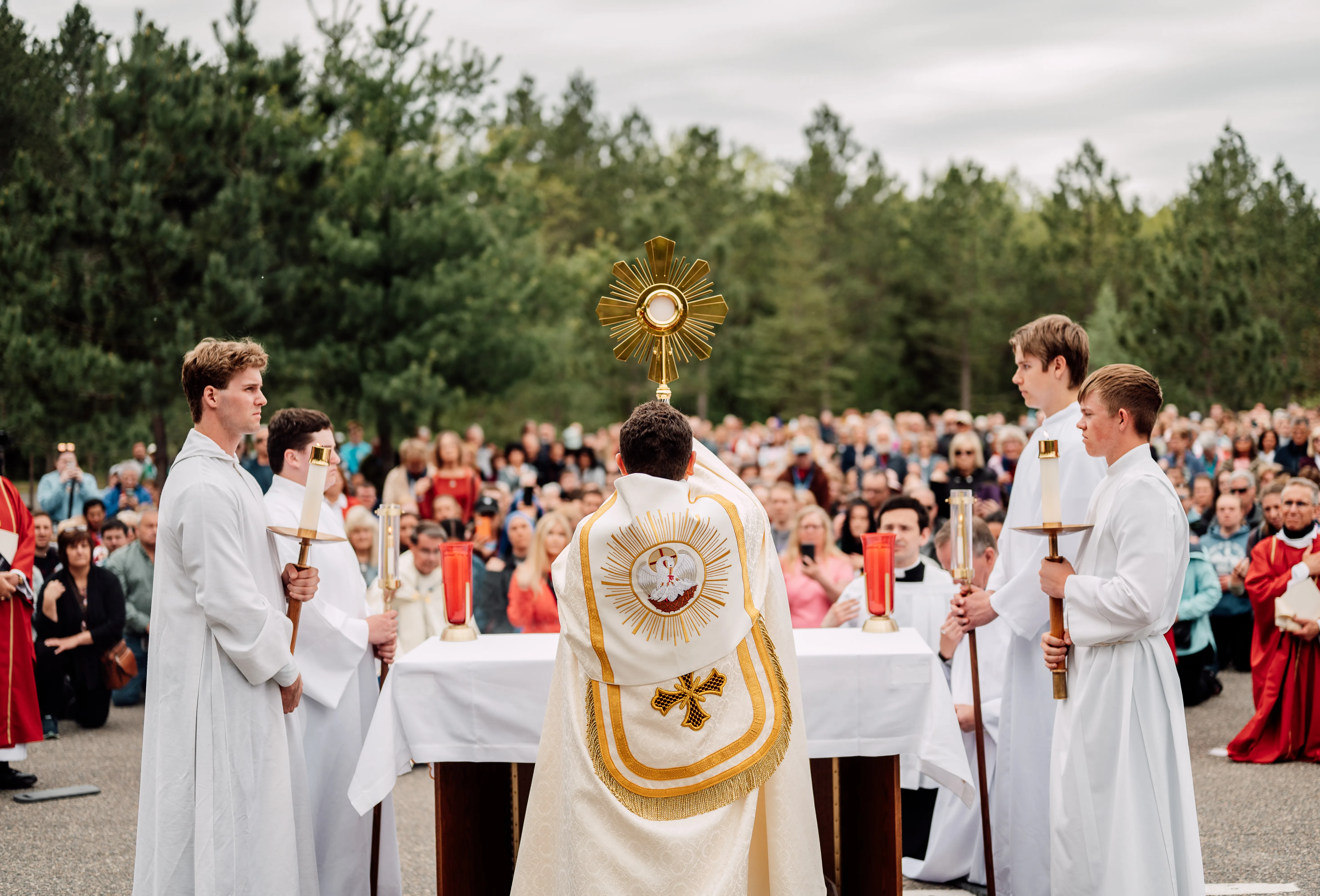 Bishop Andrew Cozzens of Crookston, Minnesota, blesses the crowd with the Eucharist in a monstrance during an outdoor Pentecost Sunday Mass on May 19, 2024, in Bemidji, Minnesota. The Mass at the headwaters of the Mississippi River marked the start of the National Eucharistic Pilgrimage, a four-route trek consisting of Eucharistic processions, community service, and other events that culminates in July at the National Eucharistic Congress in Indianpolis.?w=200&h=150