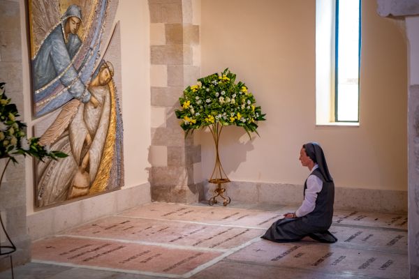 Sister Valentina Sala, the current provincial of the congregation of the Sisters of St. Joseph of the Apparition for the Holy Land, prays at the tomb of Sister Josephine Rumèbe, founder of the convent and the church in Kiryat Yearim. “The first time I came here for a few weeks, a sister took me to Kiryat Yearim. I knelt at Sister Josephine's tomb and prayed to return if that was God’s will,” she recounted to CNA. Credit: Marinella Bandini