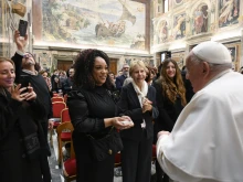 Pope Francis greets artists and participants of the 2024 Vatican Christmas Concert in the Clementine Hall on Dec. 14, 2024.