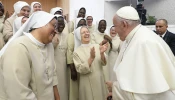 Pope Francis laughs with some religious sisters at his general audience in the Vatican’s Paul VI Hall on Aug. 30, 2023.