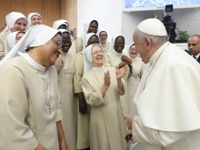 Pope Francis laughs with some religious sisters at his general audience in the Vatican’s Paul VI Hall on Aug. 30, 2023.