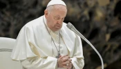 Pope Francis prays at his general audience Dec. 20, 2023, in Paul VI Hall at the Vatican.