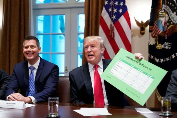 Then-U.S. Rep. Sean Duffy (left) participates in a meeting with President Donald Trump, who holds a tariff table as he speaks on Jan. 24, 2019, in the Cabinet Room of the White House. Credit: MANDEL NGAN/AFP via Getty Images