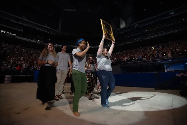 Perpetual Pilgrims from the St. Juan Diego Route process into Lucas Oil Stadium with an image of their patron saint. Credit: Jeffrey Bruno