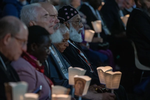 Participants hold candles as they pray during an ecumenical prayer service on Oct. 11, 2024, in Protomartyrs Square at the Vatican. Credit: Daniel Ibañez/CNA