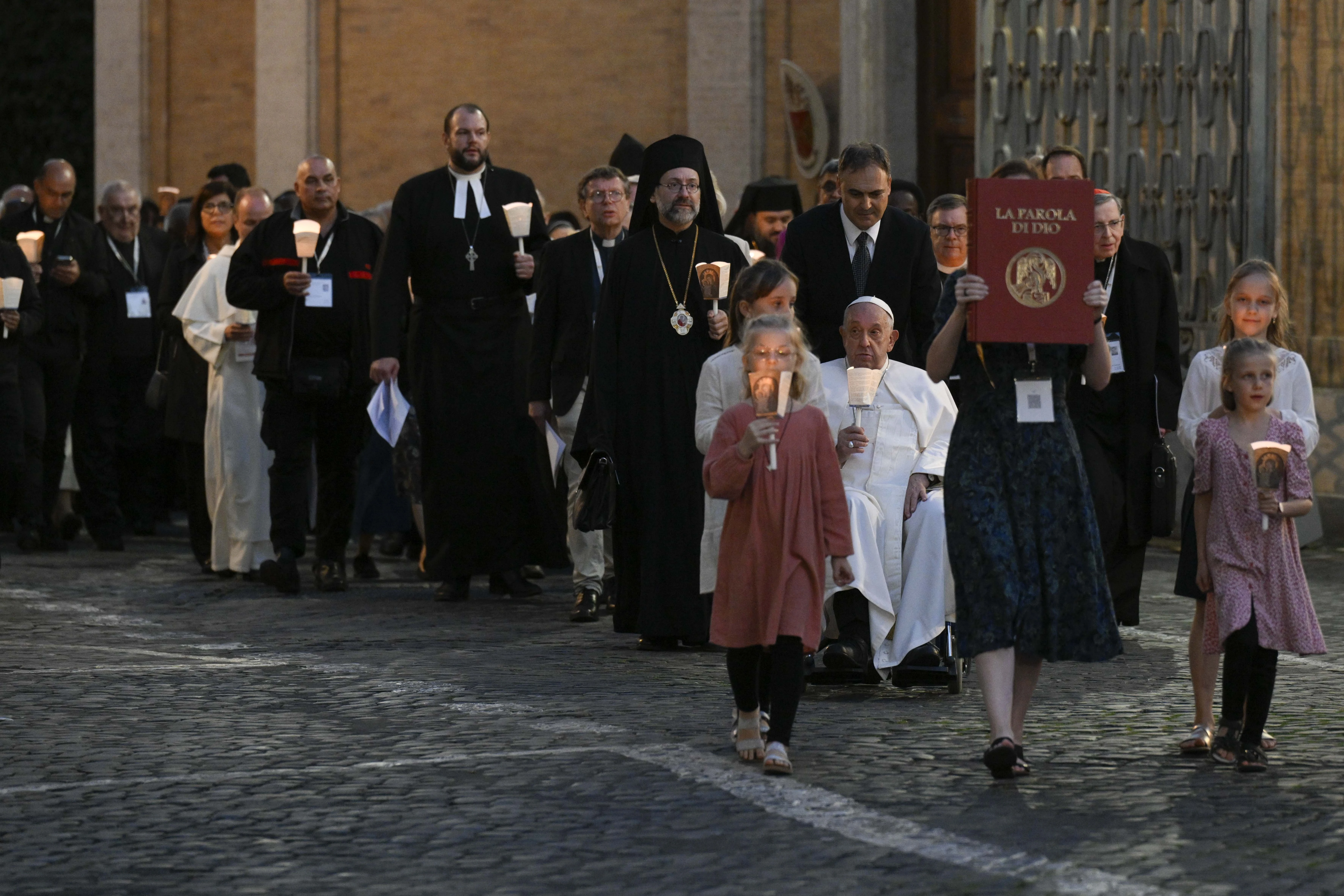 Young people lead a procession in Protomartyrs Square at the Vatican for an ecumenical prayer service on Oct. 11, 2024.?w=200&h=150