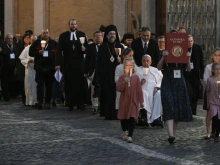 Young people lead a procession in Protomartyrs Square at the Vatican for an ecumenical prayer service on Oct. 11, 2024.