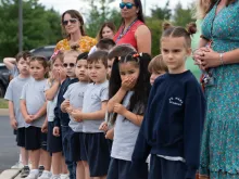 School children from St. Mary Academy watch the Eucharistic Procession on the campus of their home parish, St. Mary
of the Pines Church, Manahawkin, New Jersey, May 29, 2024.