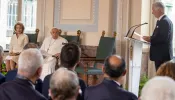 Pope Francis sits next to Queen Mathilde and listens as King Philippe (far right) speaks during a meeting between the pope and dignitaries in the Grand Gallery of Belgium’s Laeken Castle on Friday, Sept. 27, 2024.