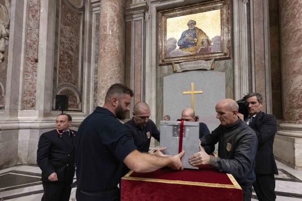 The metal box is removed from inside the wall. Credit: Vatican Media