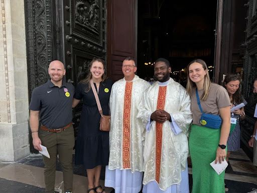 Several of the FOCUS Varsity Catholic missionaries pose for a picture alongside Father Joseph Fitzgerald and Father Jason Nioka after the Holy Games Opening Mass at La Madeleine Catholic Church. Credit: Amber Moseley/FOCUS Varsity Catholic