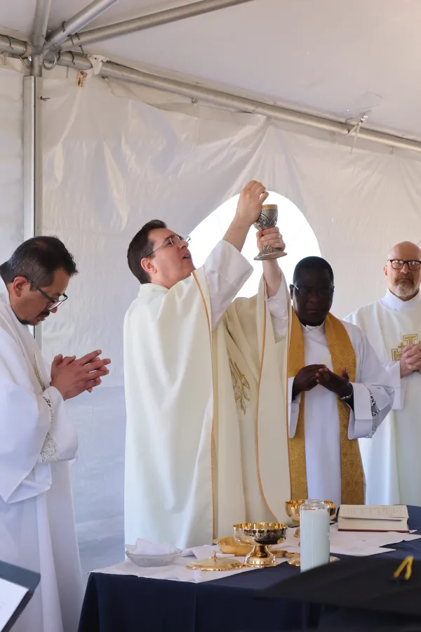 Father Gregg Pederson and Father Crispan Kibambe celebrated the baccalaureate Mass in a tent on the new grounds of St. John Paul II High School. Pearson is pastor of Our Lady of the Valley Parish, which hosted the school for four years. Kibambe is the parochial vicar at St. Mary Parish. Credit: Monica Yee/St. John Paul II High School