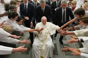 Pope Francis greets altar servers from France