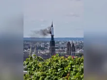 Smoke billows from the spire of Rouen Cathedral in Rouen, northern France, on July 11, 2024.