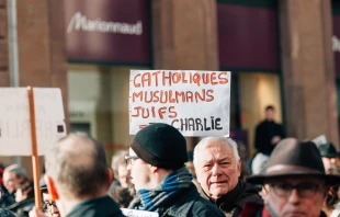 People in Strasbourg, France, hold placards reading "Catholics, muslims, jews all are Charlie" during a unity rally on Jan. 11, 2015 following a mass shooting by Muslim terrorists at the offices of the French satirical weekly newspaper Charlie Hebdo in Paris. Shutterstock