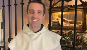 Father Michael-Joseph Paris, OCD, in front of St. Thérèse of Lisieux’s tomb.