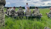 Father Adam Muda, a chaplain for the U.S. Army, celebrates Mass on the field with soldiers while in Germany.