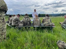 Father Adam Muda, a chaplain for the U.S. Army, celebrates Mass on the field with soldiers while in Germany.