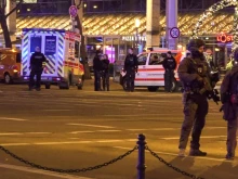 Police and ambulances stand next to a Christmas market where a car crashed into a crowd injuring between 60 and 80 people, according to a spokesman for the local rescue service, on Dec. 20, 2024, in Magdeburg, eastern Germany.