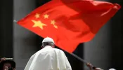 A worshiper waves the flag of China as Pope Francis leaves following the weekly general audience on June 12, 2019, at St. Peter's Square at the Vatican.