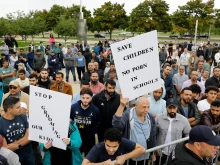 Demonstrators who support keeping inappropriate books out of libraries gather during a protest outside of the Henry Ford Centennial Library in Dearborn, Michigan, on Sept. 25, 2022.