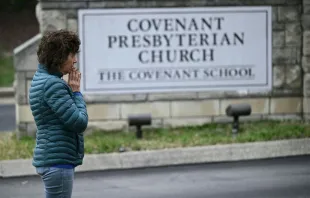 A woman prays at a makeshift memorial for victims outside the Covenant School building at the Covenant Presbyterian Church on March 28, 2023, following the March 27, 2023, shooting at the school in Nashville, Tennessee. Credit: Photo by BRENDAN SMIALOWSKI/AFP via Getty Images