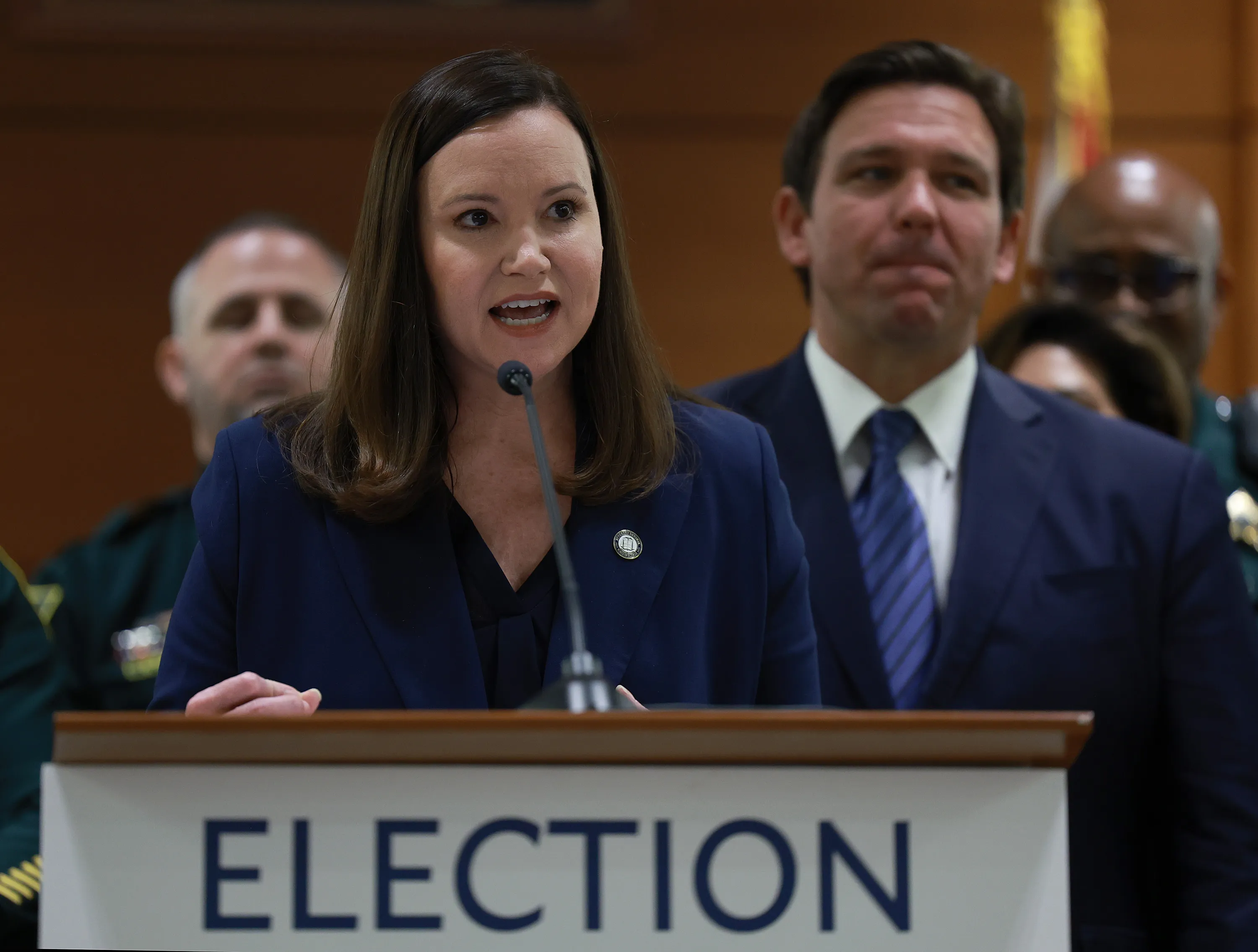 Florida Gov. Ron DeSantis listens as Florida Attorney General Ashley Moody speaks during a press conference at the Broward County Courthouse on Aug. 18, 2022, in Fort Lauderdale, Florida.?w=200&h=150