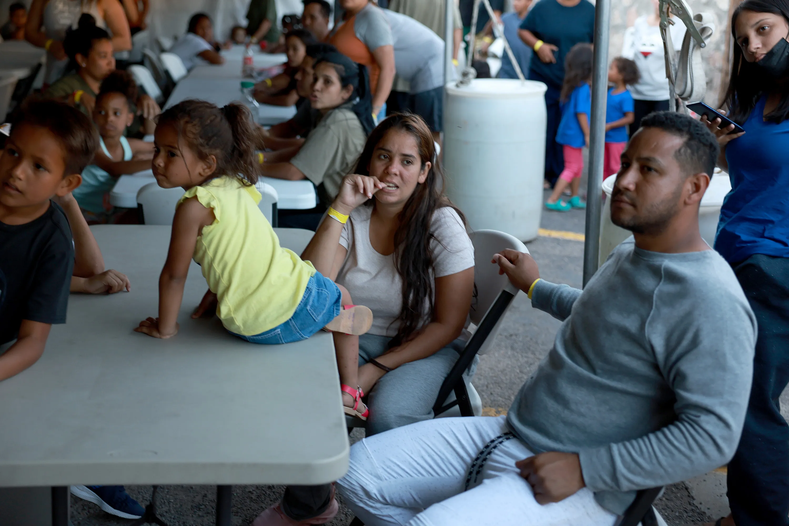 Dainelys Soto, Genesis Contreras, and Daniel Soto, who arrived from Venezuela after crossing the U.S. border from Mexico, wait for dinner at a hotel provided by the Annunciation House on Sept. 22, 2022, in El Paso, Texas.?w=200&h=150