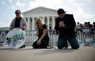 (left to right) Rev. Pat Mahoney, Peggy Nienaber of Faith and Liberty, and Mark Lee Dickson of Right to Life East Texas pray in front of the U.S. Supreme Court on April 21, 2023, in Washington, D.C. Organized by The Stanton Public Policy Center/Purple Sash Revolution, the small group of demonstrators called on the Supreme Court to affirm Federal District Court Judge Matthew Kacsmaryk’s ruling that suspends the Food and Drug Administration’s approval of the abortion pill mifepristone. Credit: Chip Somodevilla/Getty Images