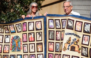 Abuse victims and their supporters hold quilts bearing portraits of abused children while gathered outside the Cathedral of Our Lady of the Angels in Los Angeles on Feb. 1, 2013, one day after the release of personnel files of priests accused of sexual misconduct. Credit: FREDERIC J. BROWN/AFP via Getty Images