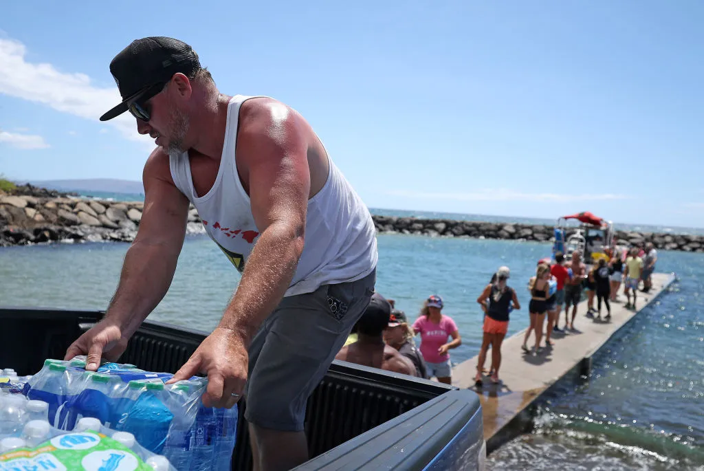 Volunteers load water onto a boat to be transported to West Maui from the Kihei boat landing on Aug. 13, 2023 in Kihei, Hawaii.?w=200&h=150