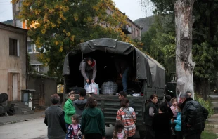 Refugees load a truck in Goris on Sept. 26, 2023, before leaving to Yerevan. A continuous stream of vehicles crept along the only road out of Nagorno-Karabakh toward Armenia, carrying tens of thousands of refugees now faced with an uncertain future. Credit: Photo by ALAIN JOCARD/AFP via Getty Images