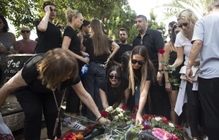 Family and friends of May Naim, 24, who was murdered by Palestinians militants at the "Supernova" festival near the Israeli border with Gaza Strip, react during her funeral on Oct. 11, 2023, in Gan Haim, Israel. Credit: Amir Levy/Getty Images