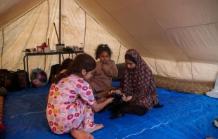 Palestinian children rest in a refugee tent along the Gaza Strip on Oct. 20, 2023, in Khan Yunis, Gaza. Credit: Ahmad Hasaballah/Getty Images