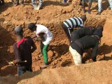 This image grab made from an AFPTV video taken in Maiyanga village in Bokkos local government on Dec. 27, 2023, shows families burying in a mass grave their relatives killed in deadly attacks conducted by armed groups in Nigeria's central Plateau state.