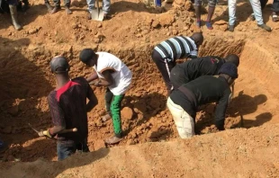 This image grab made from an AFPTV video taken in Maiyanga village in Bokkos local government on Dec. 27, 2023, shows families burying in a mass grave their relatives killed in deadly attacks conducted by armed groups in Nigeria's central Plateau state. Credit: KIM MASARA/AFPTV/AFP via Getty Images